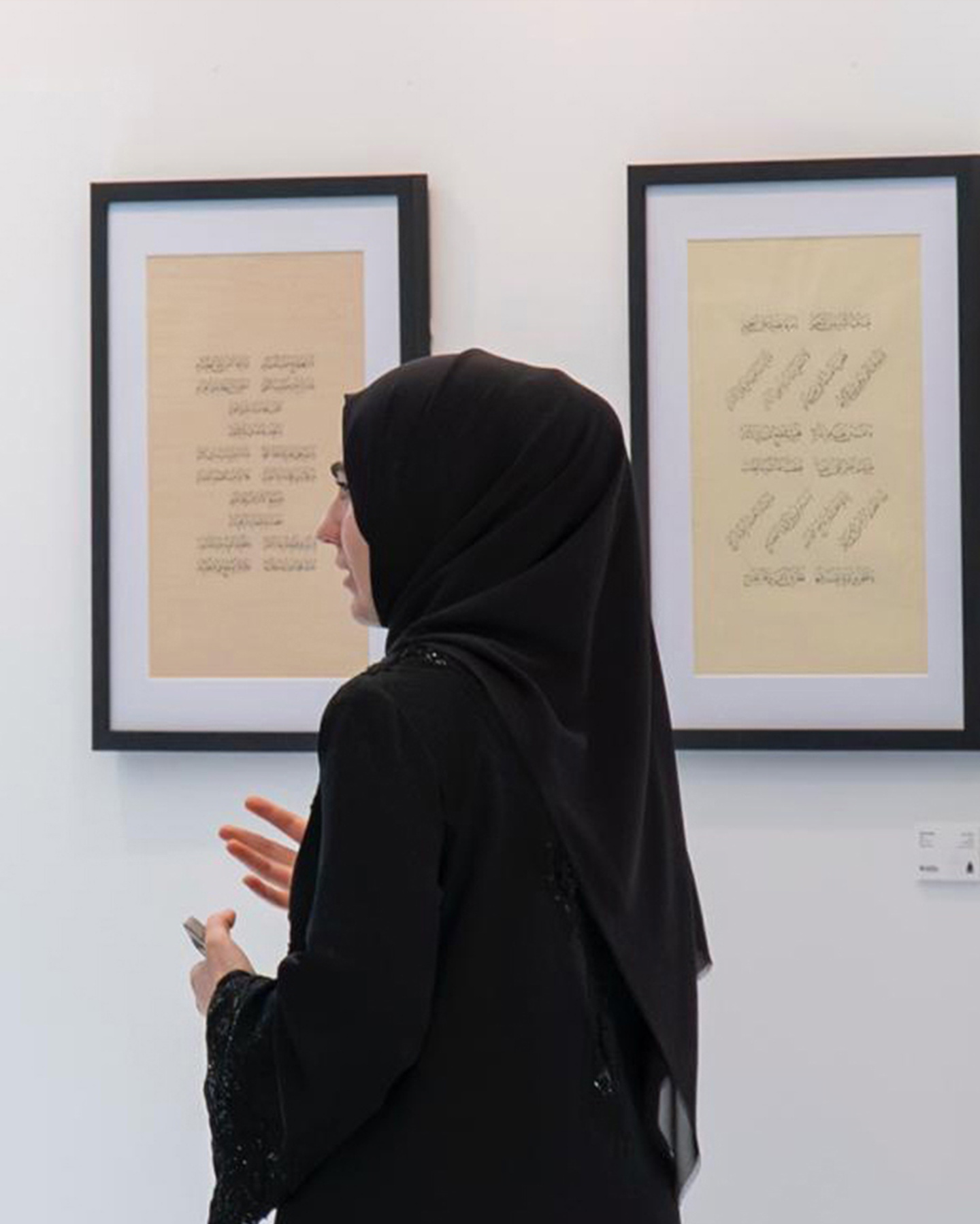 Elif Hale Gokcen at exhibition with her works