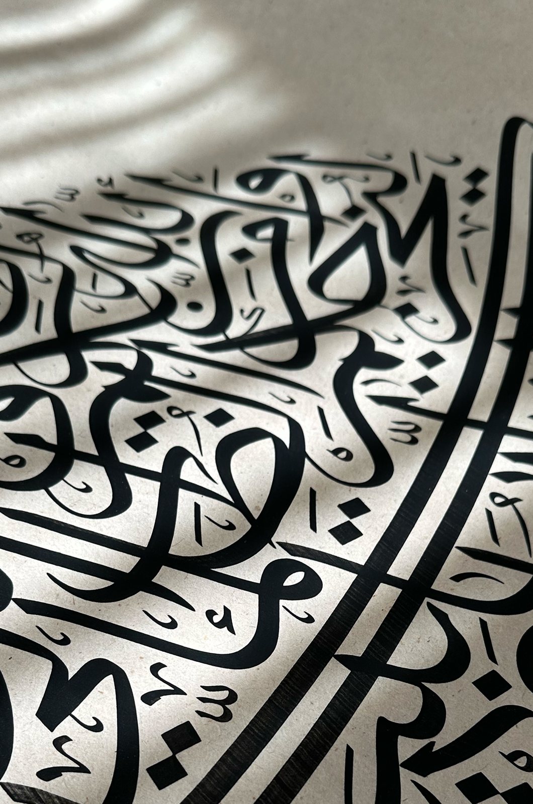 Detail — black Thuluth under raking light